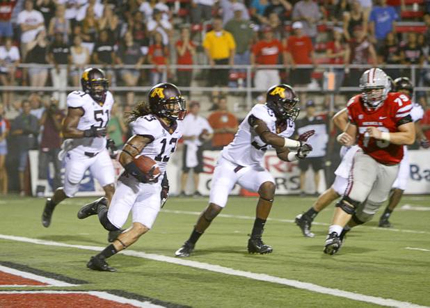 Minnesota's Derrick Wells runs the ball out of the end zone after incepting a pass in the third overtime period during UNLV's season opener at Sam Boyd Stadium Thursday, Aug. 30, 2012.