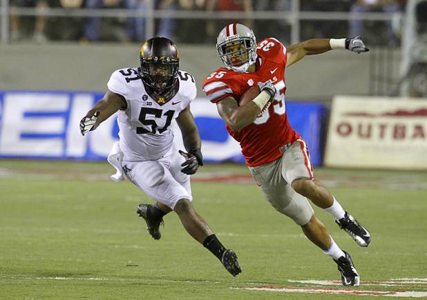 UNLV's Tim Cornett carries the ball past Minnesota's Keanon Cooper during UNLV's season opener at Sam Boyd Stadium Thursday, Aug. 30, 2012.