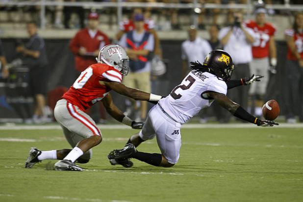 Under pressure from UNLV's Kenny Brown, left, Minnesota's Troy Stoudermire loses control of the ball during UNLV's season opener against Minnesota at Sam Boyd Stadium Thursday, Aug. 30, 2012. UNLV recovered the ball, setting up a touchdown drive.