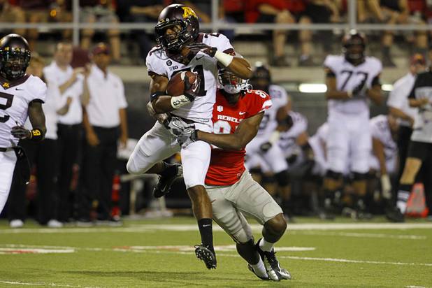 UNLV's Devante Davis tackles Brock Vereen after an interception during UNLV's season opener against Minnesota at Sam Boyd Stadium Thursday, Aug. 30, 2012.  
