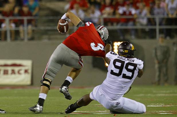 UNLV quarterback Nick Sherry is taken down by Ra'Shede Hageman during UNLV's season opener against Minnesota at Sam Boyd Stadium Thursday, Aug. 30, 2012.  