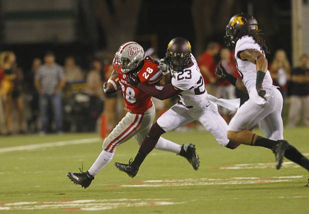 UNLV'S Bradley Randle is tackled by Minnesota's Michael Carter during UNLV's season opener against Minnesota at Sam Boyd Stadium Thursday, Aug. 30, 2012.  