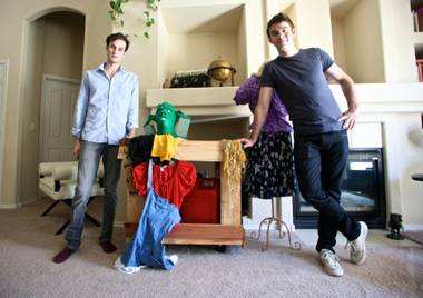 Spencer Novich (left) and Brett Alters pose with props and costumes for their original production “Two Little Girls in the Bayou.” The pair used the crowd-funding website Kickstarter to raise $10,000 for the production. 