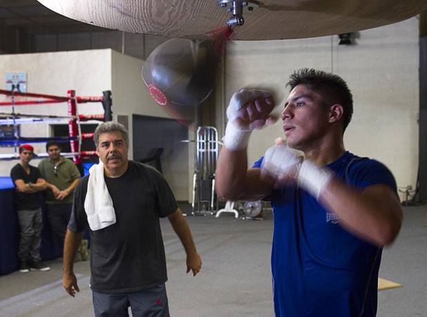 Las Vegan welterweight boxer Jessie Vargas hits a speed bag as trainer Robert Alcazar looks on during a workout at Top Rank Gym Tuesday Sept. 4, 2012. Vargas will fight Aron Martinez of Los Angeles at the Hard Rock Hotel on Thursday, September 13.