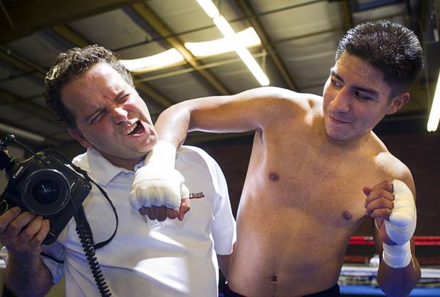 Las Vegan welterweight boxer Jessie Vargas clowns around with Top Rank photographer Chris Farina after a workout at Top Rank Gym Tuesday Sept. 4, 2012. Vargas will fight Aron Martinez of Los Angeles at the Hard Rock Hotel on Thursday, September 13.