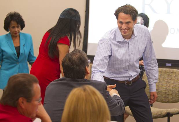 Craig Romney, right, the youngest son of GOP presidential candidate Mitt Romney, greets people as he arrives for a Hispanic small business dialogue at the Greater Las Vegas Association of Realtors offices Wednesday, Sept. 5, 2012.