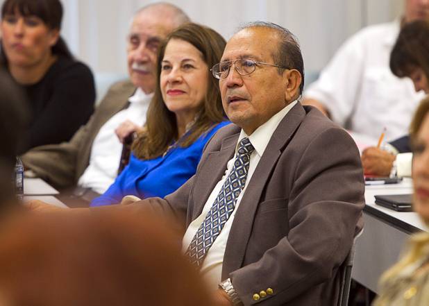 Rolando Varela, enter, listens to Craig Romney, the youngest son of GOP presidential candidate Mitt Romney, during a Hispanic small business dialogue at the Greater Las Vegas Association of Realtors offices Wednesday, Sept. 5, 2012.