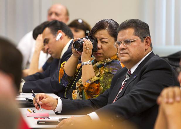 A woman takes a photo of Craig Romney, the youngest son of GOP presidential candidate Mitt Romney, during a Hispanic small business dialogue at the Greater Las Vegas Association of Realtors offices Wednesday, Sept. 5, 2012.