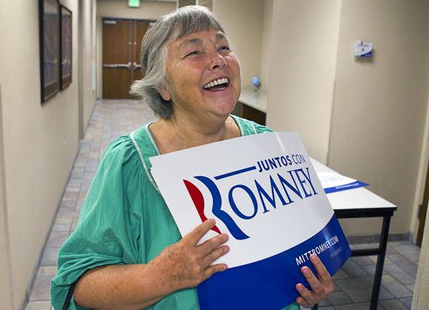 Mitt Romney supporter Leslie Monson  holds a Romney campaign sign following a Hispanic small business dialogue at the Greater Las Vegas Association of Realtors offices Wednesday, Sept. 5, 2012.