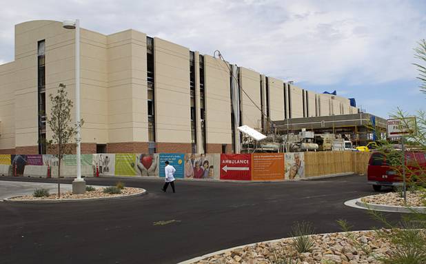 A pedestrian walks by an expansion of the MountainView Hospital on Tenaya Way at Cheyenne Avenue Wednesday, Sept. 5, 2012. The hospital is expanding its emergency department and building two more floors of hospital space. Sept. 5, 2012.