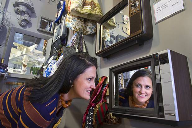 Shop owner Molly Gaddy Walters looks into a Retro TV Mirror by local artist Joel Spencer in the Artifact boutique in The Market LV portion of Tivoli Village Thursday, Sept. 6, 2012. The shop specializes in recycled, up cycled and re-purposed items.
