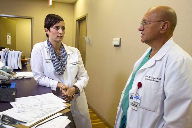 Dr. Aimee Fleury confers with Dr. Nick Spirtos, medical director of the Women's Cancer Center of Nevada, at the center Thursday, Sept. 6, 2012. Fleury, a gynecologic oncologist, joined the center this August.