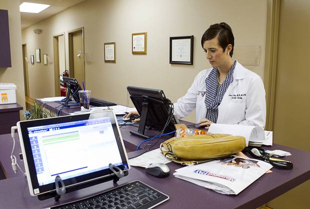 Dr. Aimee Fleury pulls up a patient record at a nurse's station in the Women's Cancer Center of Nevada Thursday, Sept. 6, 2012. Fleury, a gynecologic oncologist, joined the center this August.