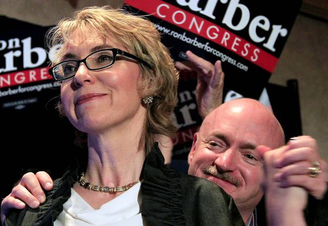 In this June 12, 2012, file photo, former Arizona Rep. Gabrielle Giffords, accompanied by her husband Mark Kelly, are seen in Tucson, Ariz.