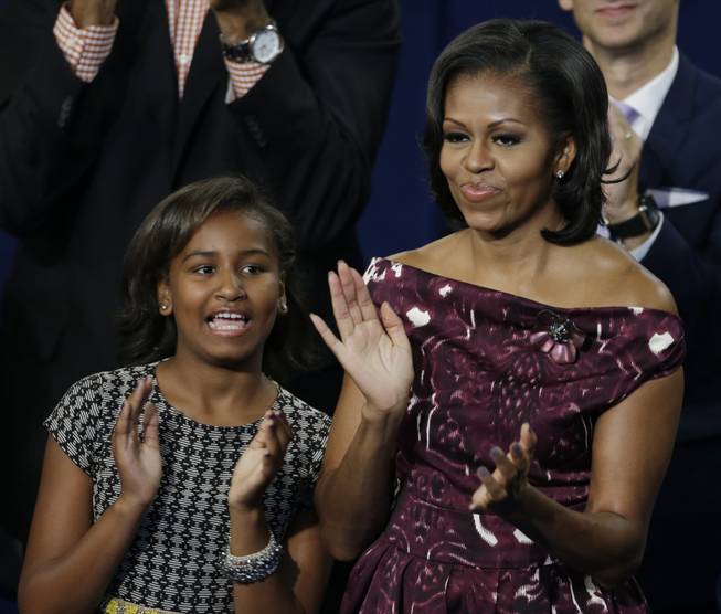 First lady Michelle Obama applauds with her daughter Sasha during President Barack Obama's speech at the Democratic National Convention in Charlotte, N.C., on Thursday, Sept. 6, 2012.