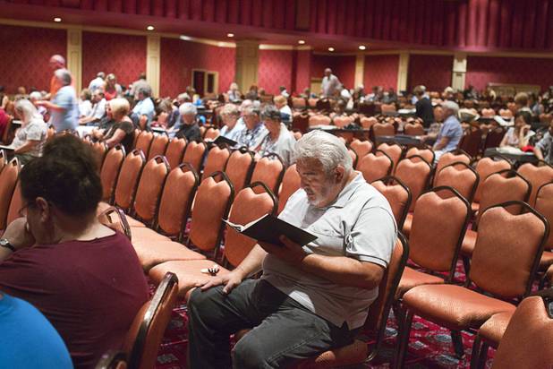 Richard Valdemar, center, worships during St. John the Baptist Catholic Church Mass at the Riverside Casino in Laughlin Sunday, Sept. 9. 2012. The church is the only Catholic church that holds weekly Mass in a casino, said Father Charlie Urnick.