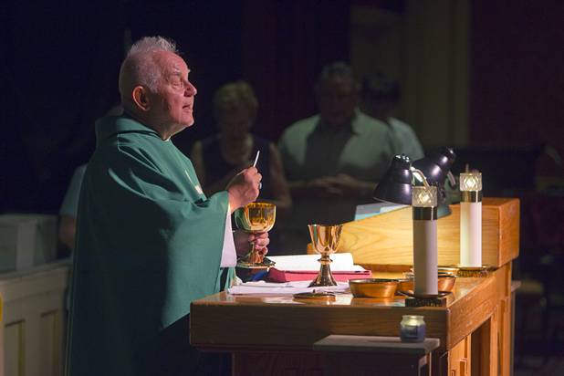Father Charlie Urnick conducts communion services during St. John the Baptist Catholic Church Mass at the Riverside Casino in Laughlin Sunday, Sept. 9. 2012. The church is the only Catholic church that holds weekly Mass in a casino, Urnick said.