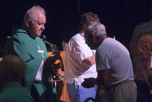 Father Charlie Urnick conducts communion services during St. John the Baptist Catholic Church Mass at the Riverside Casino in Laughlin Sunday, Sept. 9. 2012. The church is the only Catholic church that holds weekly Mass in a casino, Urnick said.