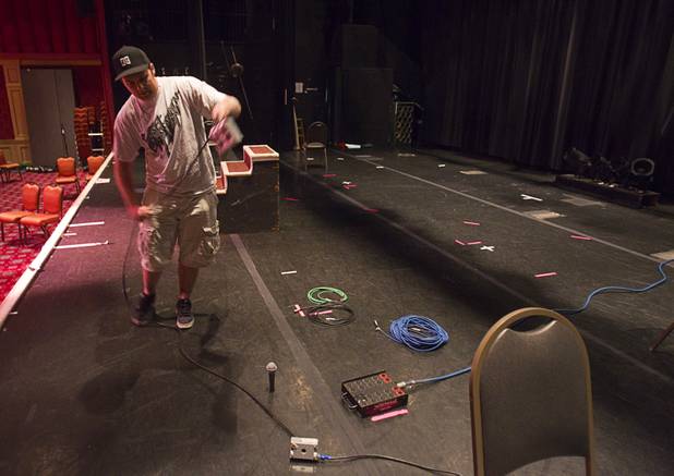 Shane Petronella clears the stage of equipment after a St. John the Baptist Catholic Church Mass at the Riverside Casino in Laughlin Sunday, Sept. 9. 2012. The church is the only Catholic church that holds weekly Mass in a casino, said Father Charlie Urnick.