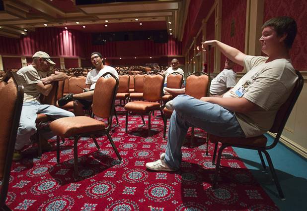 Riverside casino employees wait following St. John the Baptist Catholic Church Mass at the Riverside Casino in Laughlin Sunday, Sept. 9. 2012. After the service, the workers prepare for the evening show, in this case, the Thunder From Down Under male revue.The church is the only Catholic church that holds weekly Mass in a casino, said Father Charlie Urnick.