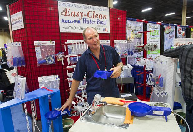 CEO Paul Pluss explains the features of the Easy-Clean Auto-Fill Water Bowl during SuperZoo, a trade show for the pet industry, at the Mandalay Bay Convention Center Tuesday, Sept. 11, 2012.