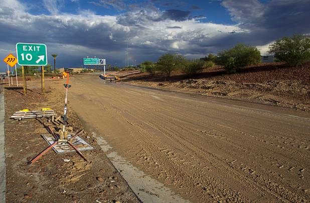 The roadway at the I-215 eastbound off-ramp to the airport connector is closed and covered with mud Tuesday, Sept. 11, 2012. Run off from heavy rains filled the roadway with mud and debris.