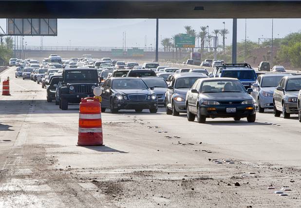 Rush hour traffic is backed up on I-215 eastbound near the off-ramp to the airport connector Tuesday, Sept. 11, 2012. Run off from heavy rains filled the roadway with mud and debris closing the off ramp and reducing eastbound traffic to two lanes.