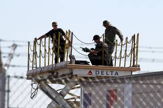 A security team takes up an elevated position as they wait for President Barack Obama to arrive at McCarran International Airport Wednesday, Sept. 12, 2012.  Obama will be making a campaign stop at Cashman Field Center.