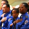 Aja Johnson, right, joins other graduates in saying the pledge of allegiance during a Transportation Security Administration (TSA) graduation ceremony Wednesday, Sept. 12, 2012, at the College of Southern Nevada Charleston campus in Las Vegas.