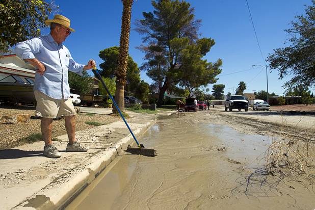 Bill Seals takes a break will trying to clean up outside of his house near the Desert Rose Golf Course Wednesday, Sept. 12, 2012. The flooding "was the worst I've ever seen" said the 44 -year Las Vegas resident.
