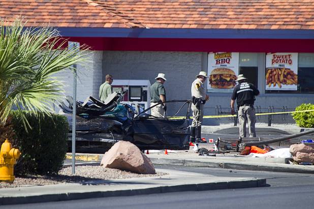 Metro Police investigate after a car crashed into a bus stop on Spring Mountain Road east of Decatur Boulevard, killing four people, on Thursday, Sept. 13, 2012.