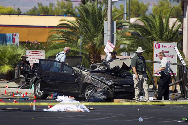 Metro Police investigate after a car crashed into a bus stop on Spring Mountain Road east of Decatur Boulevard, killing four people, on Thursday, Sept. 13, 2012.