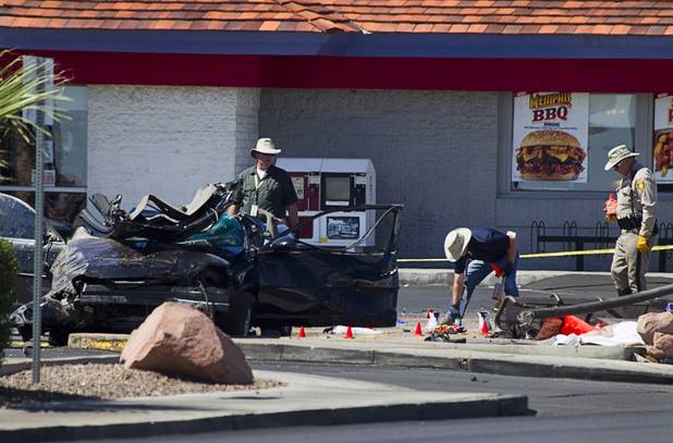Metro Police investigate after a car crashed into a bus stop on Spring Mountain Road east of Decatur Boulevard, killing four people, on Thursday, Sept. 13, 2012.