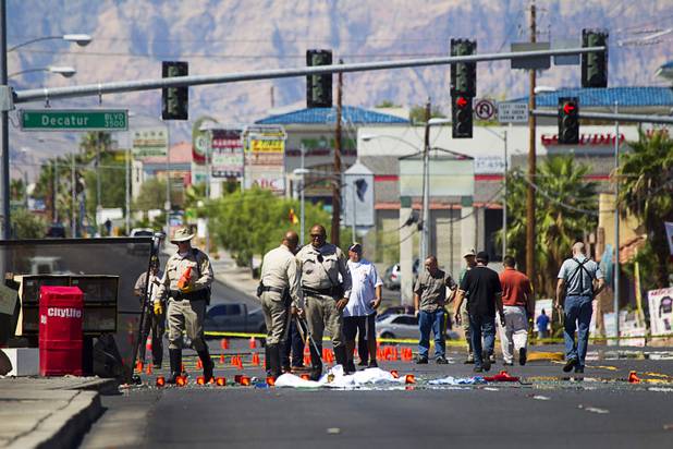 Metro Police investigate after a car crashed into a bus stop on Spring Mountain Road east of Decatur Boulevard, killing four people, on Thursday, Sept. 13, 2012.