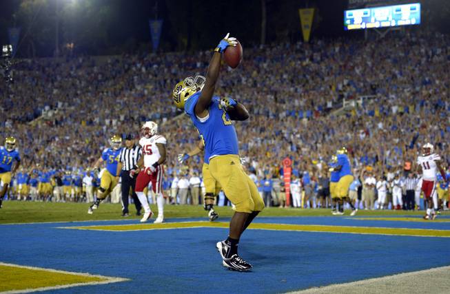 UCLA running back Johnathan Franklin celebrates after scoring a touchdown during the second half of their NCAA football game against Nebraska, Saturday, Sept. 8, 2012, in Pasadena, Calif. UCLA won 36-30.