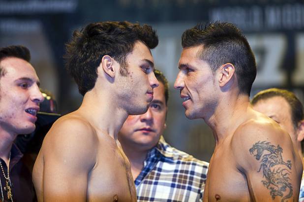 WBC middleweight champion Julio Cesar Chavez Jr. (L), son of boxing legend Julio Cesar Chavez, listens to Sergio Martinez of Argentina as they face off during an official weigh-in at the Wynn Las Vegas Resort in Las Vegas, Nevada Sept. 14, 2012. Chavez will defend his title against Martinez at the Thomas & Mack Center in Las Vegas September 15.