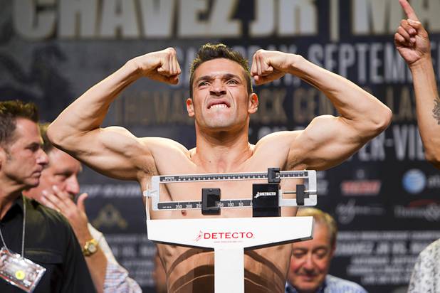 Boxer Sergio Martinez of Argentina flexes on the scale during an official weigh-in at the Wynn Las Vegas Resort in Las Vegas, Nevada Sept. 14, 2012. Martinez will challenge WBC middleweight champion Julio Cesar Chavez Jr., son of boxing legend Julio Cesar Chavez, at the Thomas & Mack Center in Las Vegas September 15.