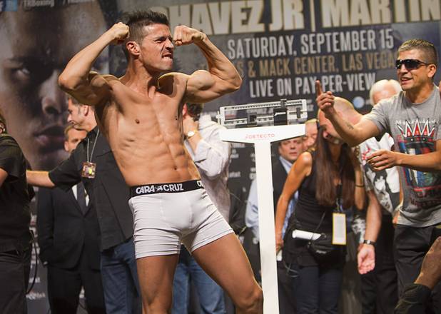 Boxer Sergio Martinez (L) of Argentina shows off his physique after making weight during an official weigh-in at the Wynn Las Vegas Resort in Las Vegas, Nevada Sept. 14, 2012. Martinez will challenge WBC middleweight champion Julio Cesar Chavez Jr., son of boxing legend Julio Cesar Chavez, at the Thomas & Mack Center in Las Vegas September 15.