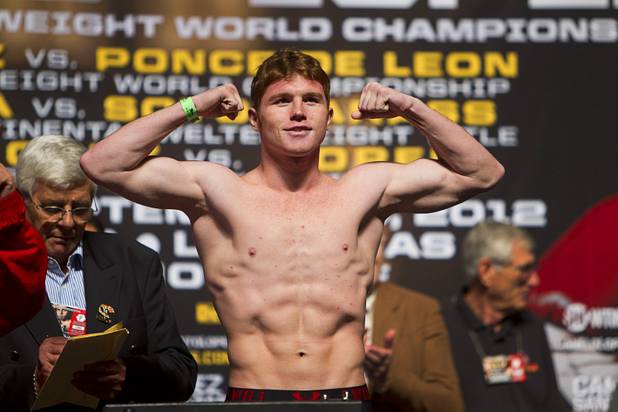 WBC super welterweight champion Canelo Alvarez of Mexico flexes on the scale during an official weigh-in at the MGM Grand Garden Arena in Las Vegas, Nevada Sept. 14, 2012. Alvarez will defend his title against Josesito Lopez of the U.S. at the the arena September 15.