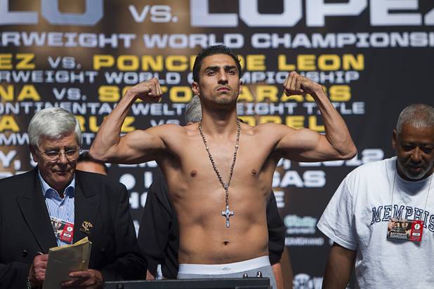 Josesito Lopez of the U.S. flexes on the scale during an official weigh-in at the MGM Grand Garden Arena in Las Vegas, Nevada Sept. 14, 2012. Lopez will challenge WBC super welterweight champion Canelo Alvarez of Mexico for the title at the the arena September 15.