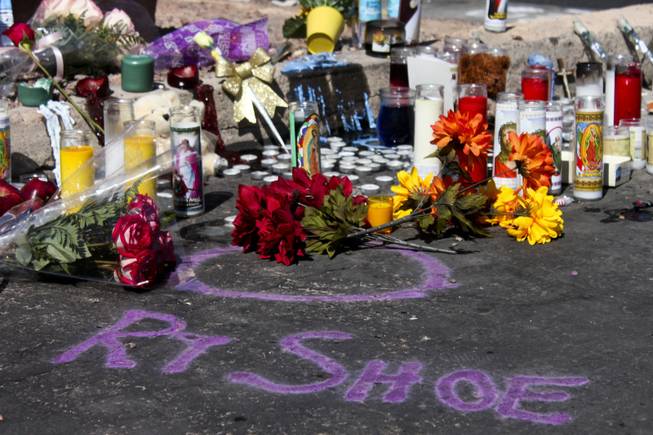 An evidence marker "RT Shoe" is seen at the memorial site of the bus stop crash Friday, Sept. 14, 2012.