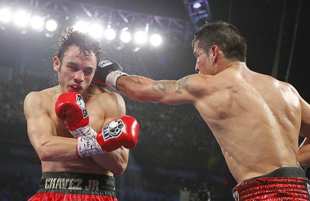 WBC middleweight champion Julio Cesar Chavez Jr. (L) of Mexico fights against Sergio Martinez of Argentina during their title fight at the Thomas & Mack Center in Las Vegas, Nevada Sept. 15, 2012.