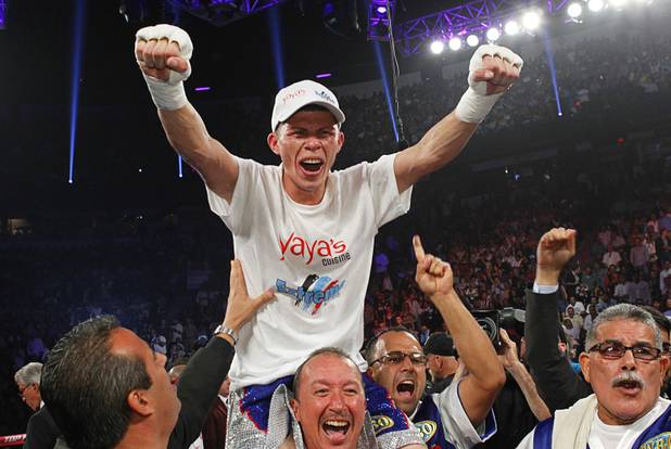 Roman Martinez of Puerto Rico celebrates his victory over Miguel Beltran Jr. of Mexico following their fight for the vacant WBO super featherweight title at the Thomas & Mack Center in Las Vegas, Nevada Sept. 15, 2012.