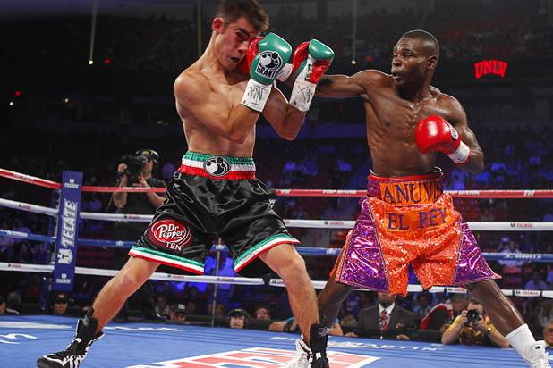 Roberto Marroquin (L) of the U.S. takes a punch from WBA super bantamweight champion Guillermo Rigondeaux (R) of Cuba during their bout at the Thomas & Mack Center in Las Vegas, Nevada Sept. 15, 2012.
