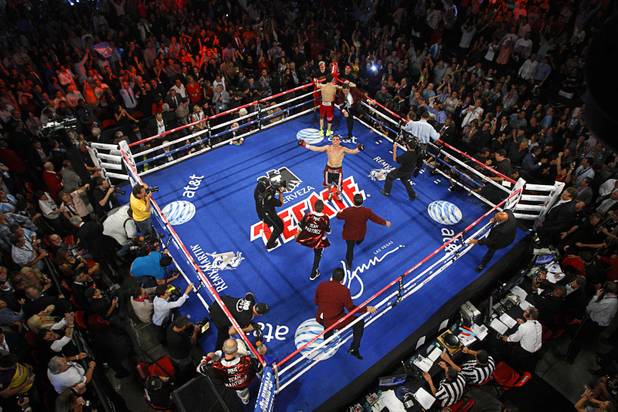 Sergio Martinez (C) of Argentina celebrates after finishing the 12th and final round of his fight against WBC middleweight champion Julio Cesar Chavez Jr. of Mexico at the Thomas & Mack Center in Las Vegas, Nevada Sept. 15, 2012. Martinez survived two knockdowns in the 12th round to take the title by unanimous decision.
