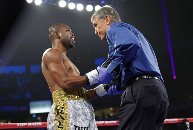 Referee Jay Nady checks on Joachim Alcine (L) of Canada hits the canvas after he was knocked down by Matthew Macklin of England during a middleweight bout at the Thomas & Mack Center in Las Vegas, Nevada Sept. 15, 2012. Macklin won with a first round TKO.