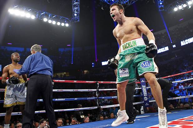 Matthew Macklin (R) of England celebrates after defeating Joachim Alcine of Canada in a middleweight bout at the Thomas & Mack Center in Las Vegas, Nevada Sept. 15, 2012. Macklin won with a first round TKO. Referee Jay Nady checks on Alcine at left.