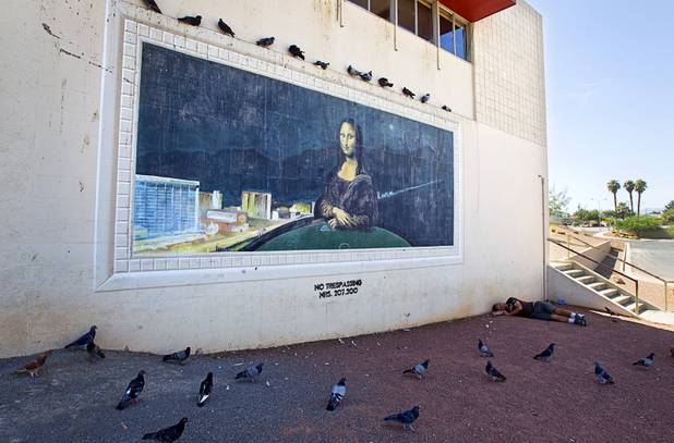 A man sleeps by a mural at the Reed Whipple Cultural Center on Las Vegas Boulevard North, part of the Cultural Corridor, in downtown Las Vegas Sunday, Sept. 16, 2012.