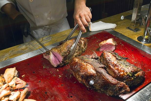A cook cuts a slice of marinated tri-tip roast at the Wicked Spoon buffet in the Cosmopolitan Tuesday, Sept. 18, 2012.
