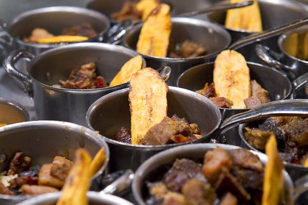 Small pots of crispy pork with rice and black beans are displayed at the Wicked Spoon buffet in the Cosmopolitan Tuesday, Sept. 18, 2012.